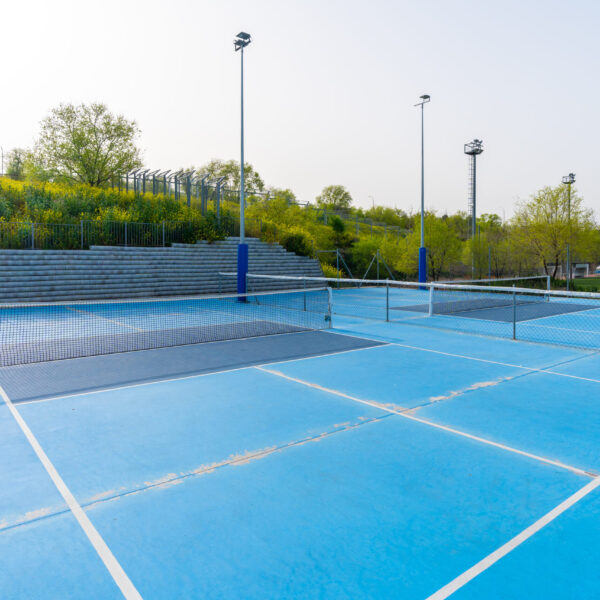 Empty new blue outdoors pickletball and tennis courts in a sunny day